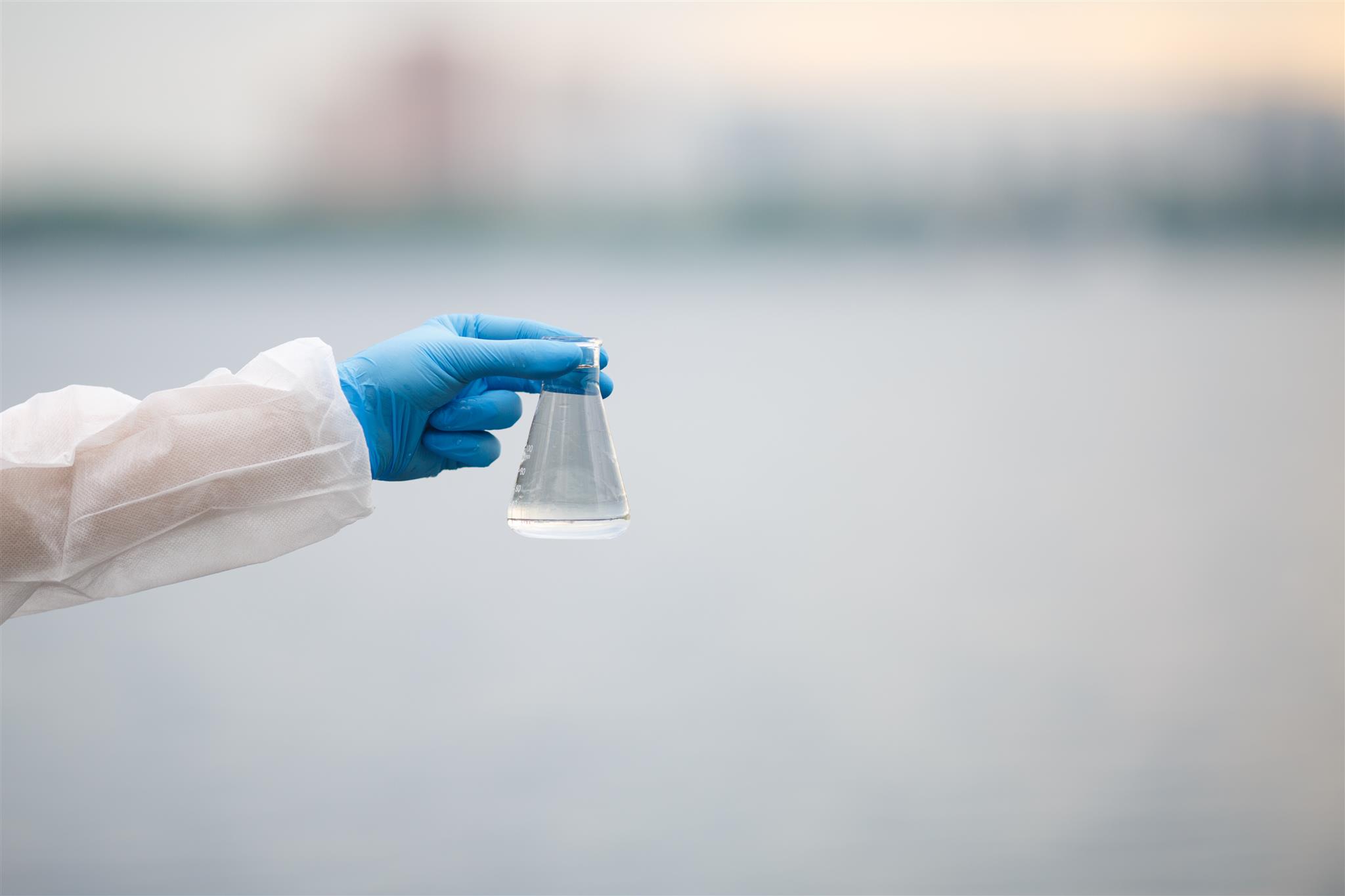 Environmental scientist holding a groundwater sample bottle
