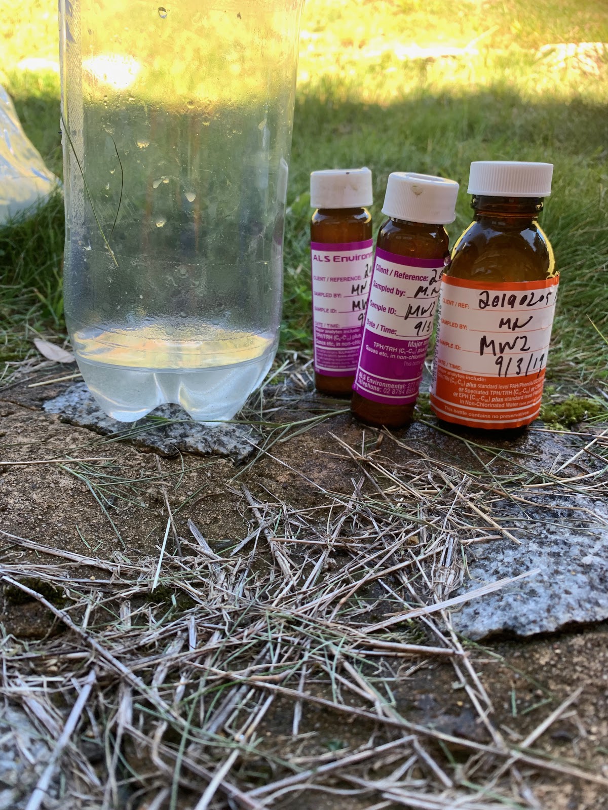 Environmental scientist undertaking water sampling in a remote alpine landscape